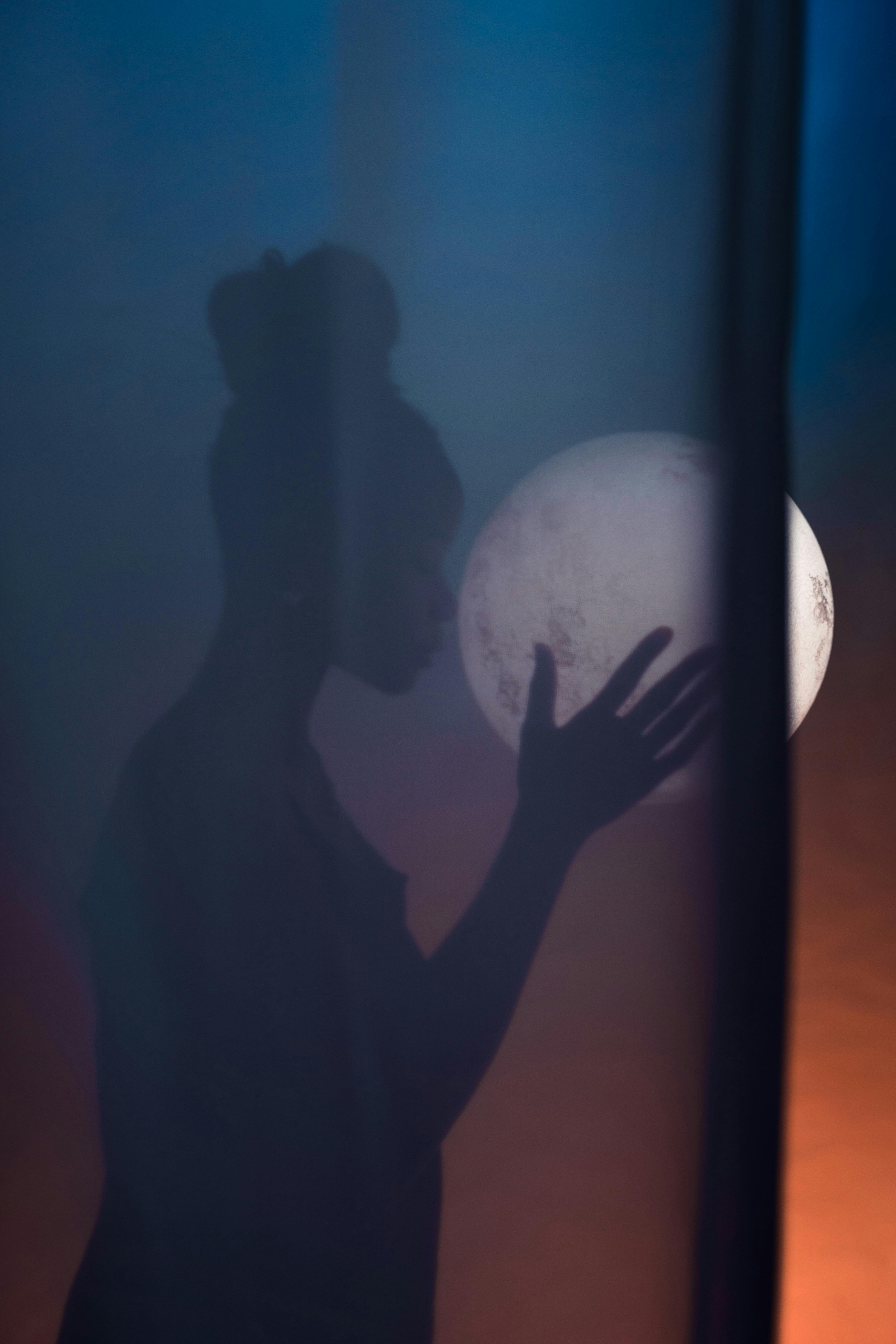 A woman holding the moon